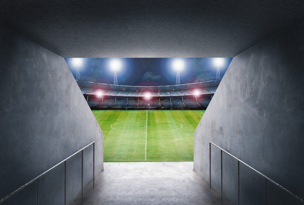 Tunnel In Stadium With Green Field